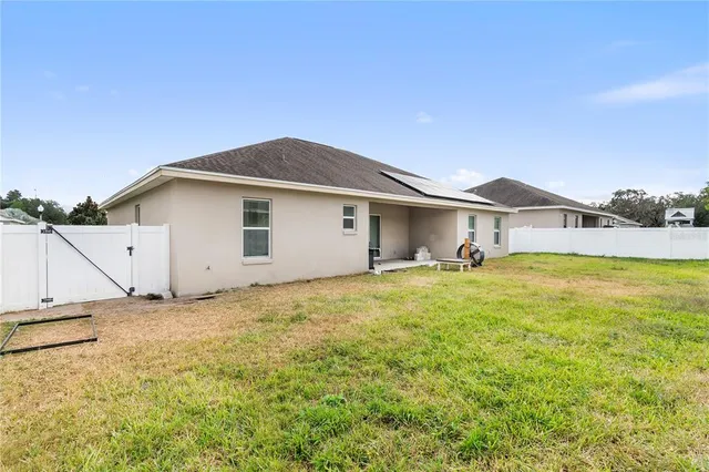 a swimming pool with an outdoor space and seating area