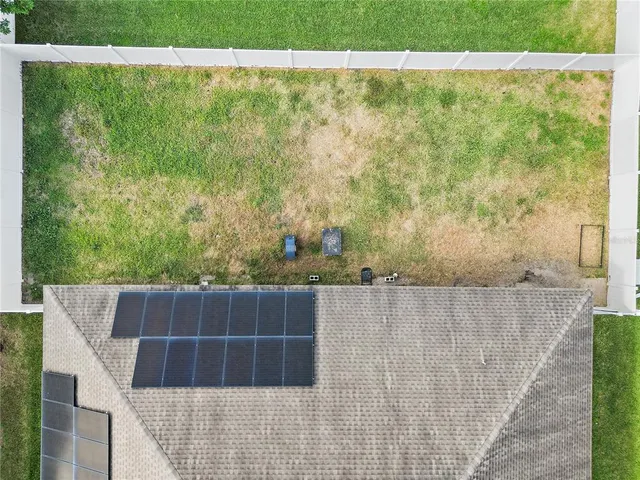 an aerial view of a house with a swimming pool yard and outdoor seating