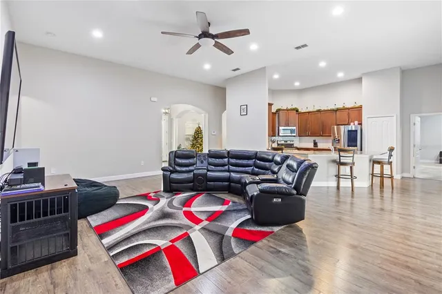 a living room with furniture and kitchen view