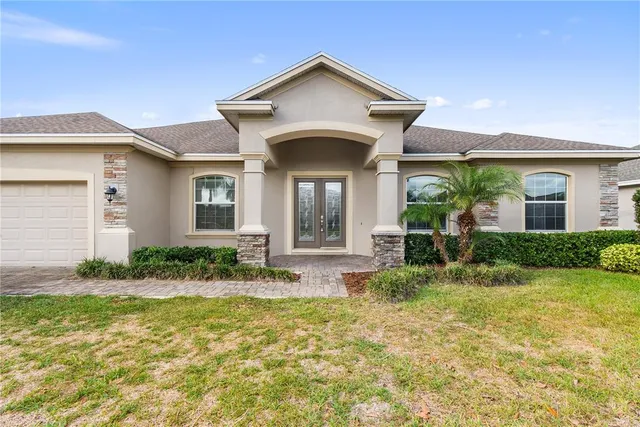 an aerial view of a house with garden space and street view