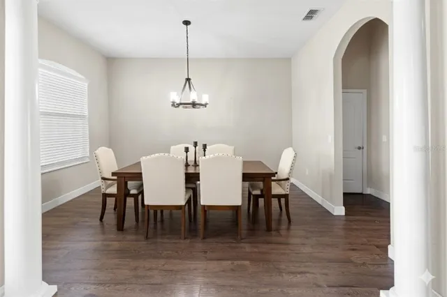 a view of a dining room with furniture and wooden floor