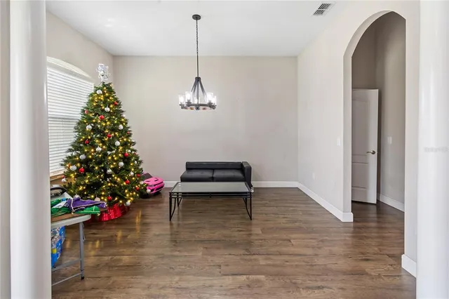 a room with lots of flowers and a chandelier