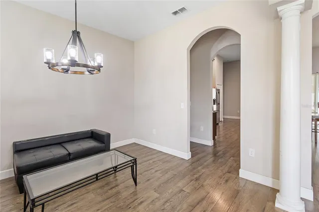 a kitchen with granite countertop a refrigerator and a stove top oven