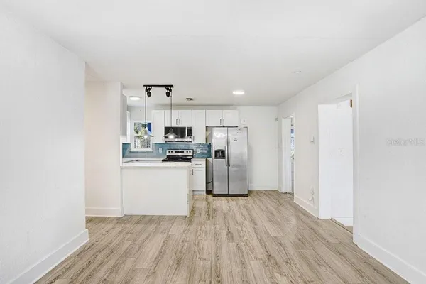 a kitchen with stainless steel appliances a refrigerator and a stove top oven
