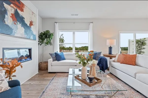 a living room with furniture and a potted plant