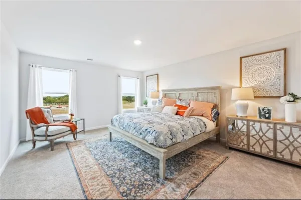 a bedroom with a bed and a couch