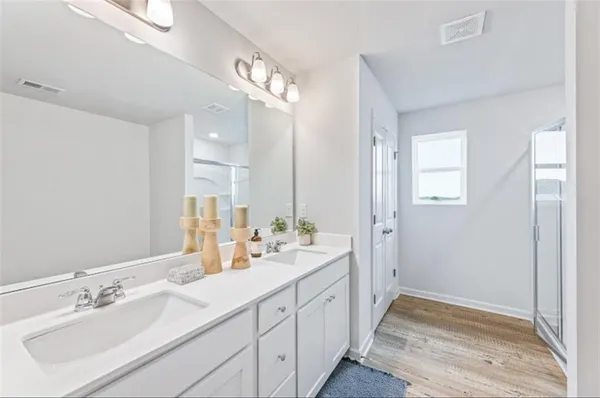 a spacious bathroom with double sink and a mirror