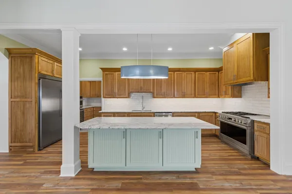 a kitchen with granite countertop cabinets stainless steel appliances and a counter space