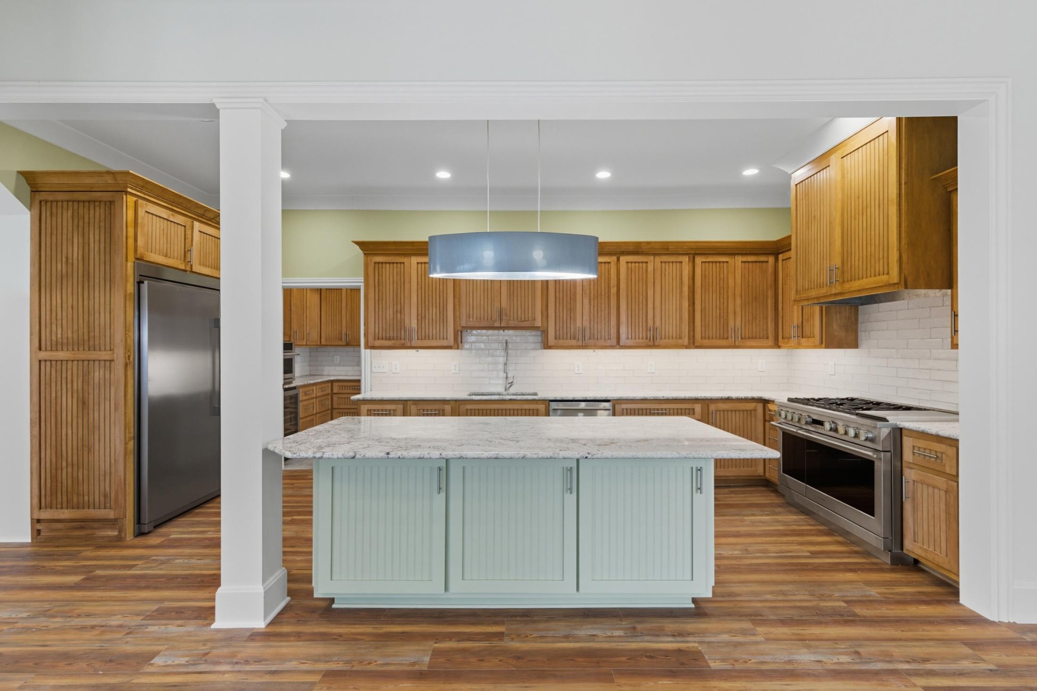 583 Bell Point Road Laceys Spring, AL 35754 - Photo 11 of 50 a kitchen with kitchen island granite countertop wooden floors and stainless steel appliances