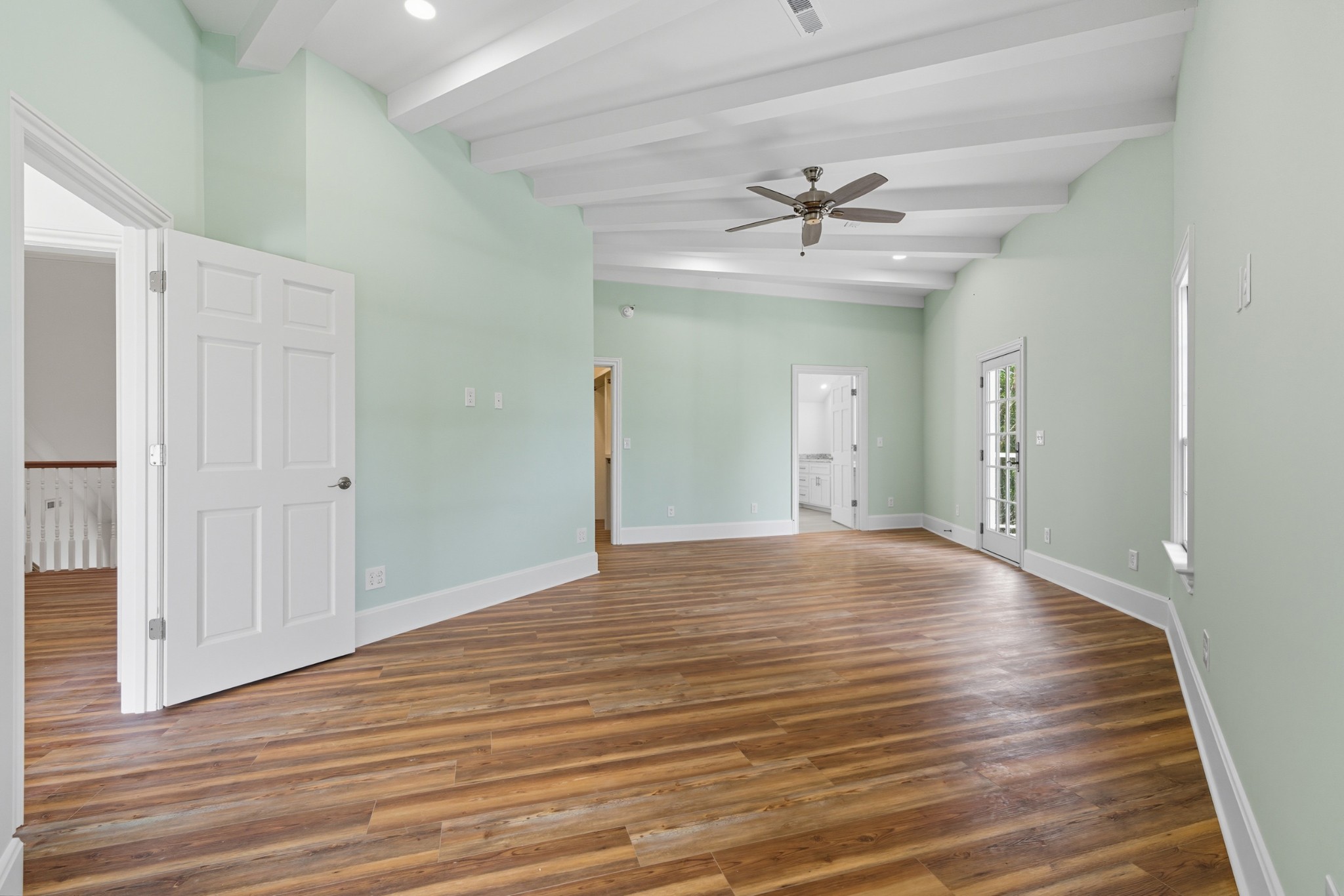 583 Bell Point Road Laceys Spring, AL 35754 - Photo 16 of 50 a view of an empty room with wooden floor and a ceiling fan