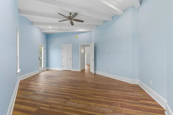 a view of room with wooden floor and ceiling fan