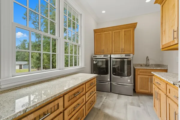 a view of a house with a yard and table and chairs