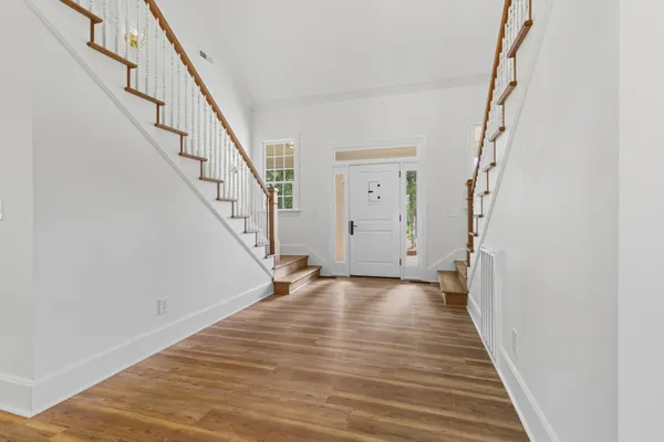 a view of an entryway with wooden floor