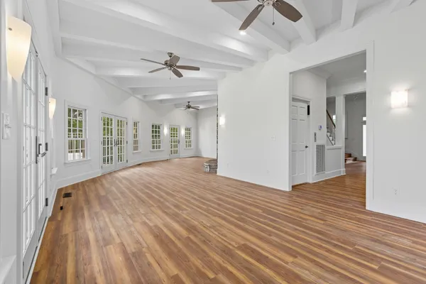 wooden floor in an empty room with a window