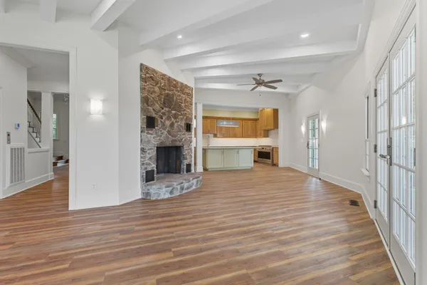 a kitchen with kitchen island granite countertop wooden floors and stainless steel appliances