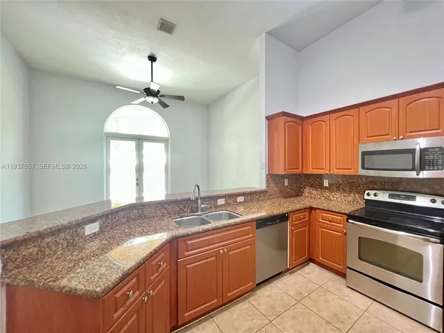 a view of a kitchen with a sink and a window