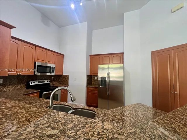 a kitchen with a refrigerator stove and a sink
