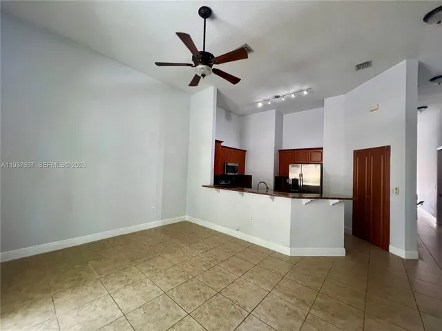 a view of a room with wooden floor and windows