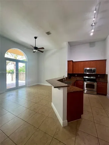a kitchen with stainless steel appliances granite countertop a sink and a stove