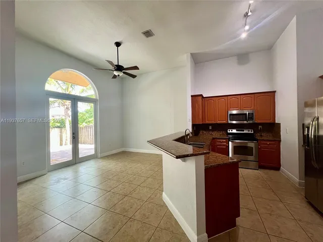 a kitchen with a stove a sink and a refrigerator