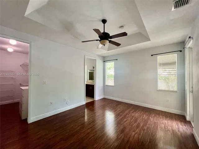 a view of a room with wooden floor and windows