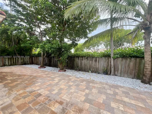 a backyard of a house with palm trees