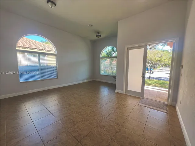 a kitchen with stainless steel appliances granite countertop a sink stove cabinets and refrigerator