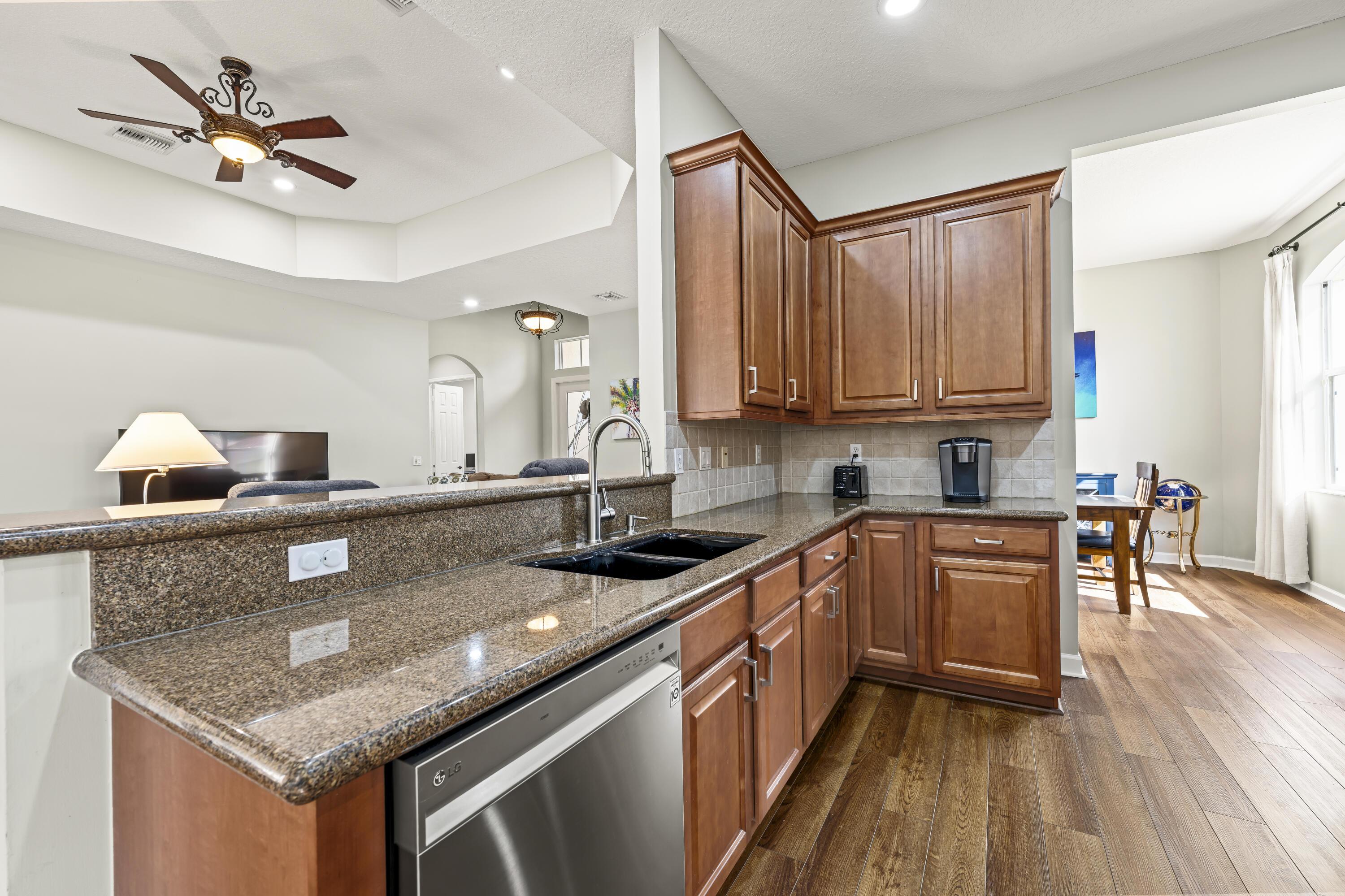 9184 Pumpkin Ridge Port St. Lucie, FL 34986 - Photo 16 of 74 a kitchen with stainless steel appliances granite countertop a sink stove and cabinets