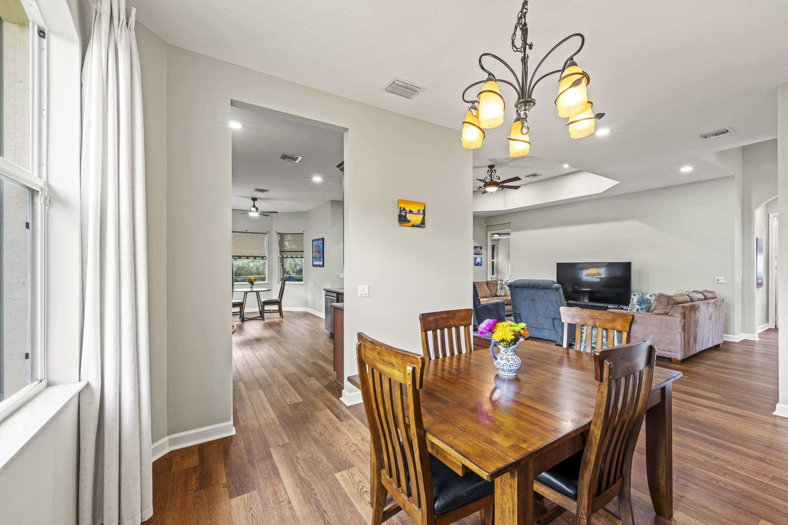 9184 Pumpkin Ridge Port St. Lucie, FL 34986 - Photo 21 of 74 a view of a dining room with furniture and wooden floor