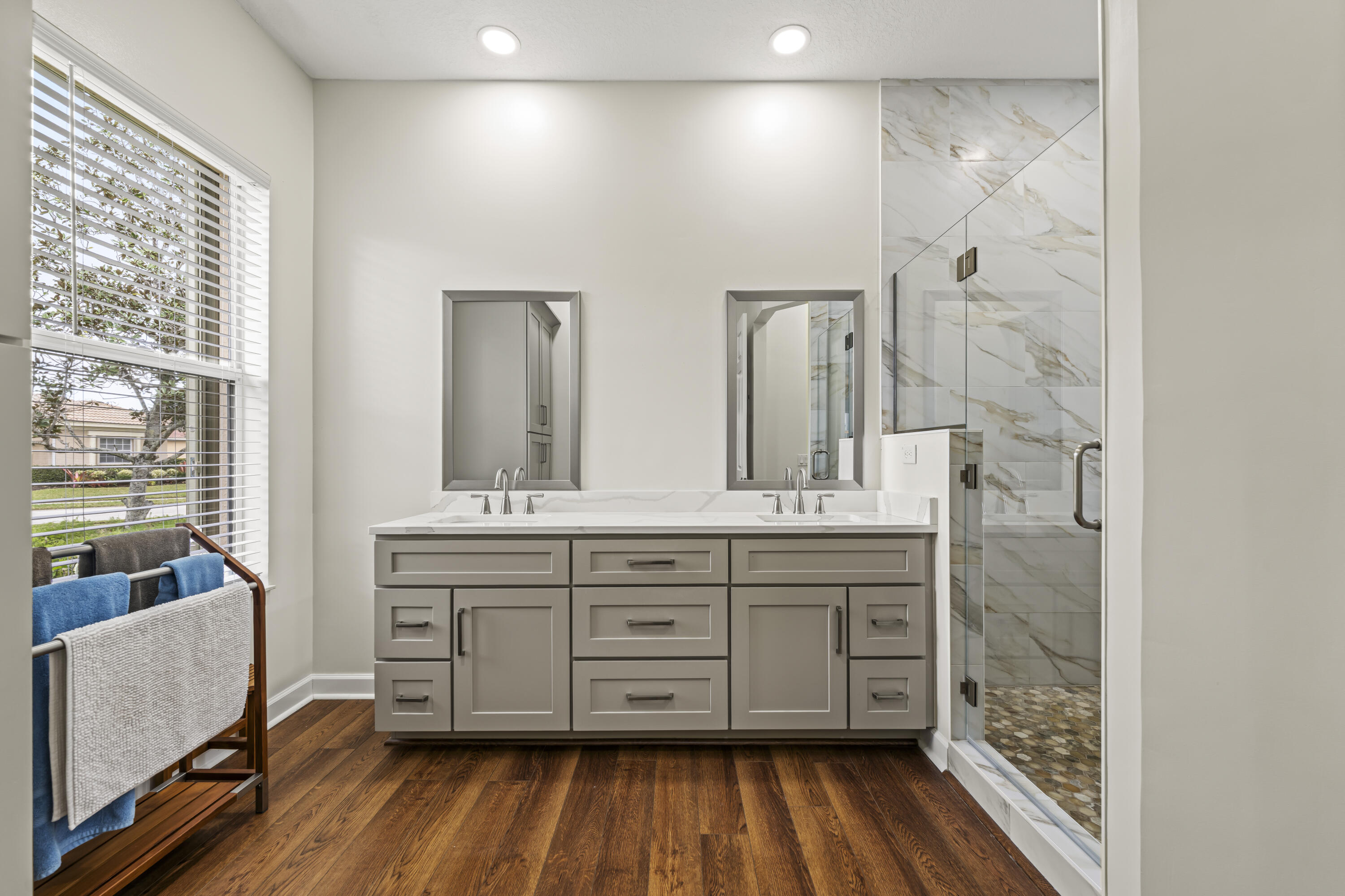 9184 Pumpkin Ridge Port St. Lucie, FL 34986 - Photo 28 of 74 a spacious bathroom with a double vanity sink a mirror and a shower