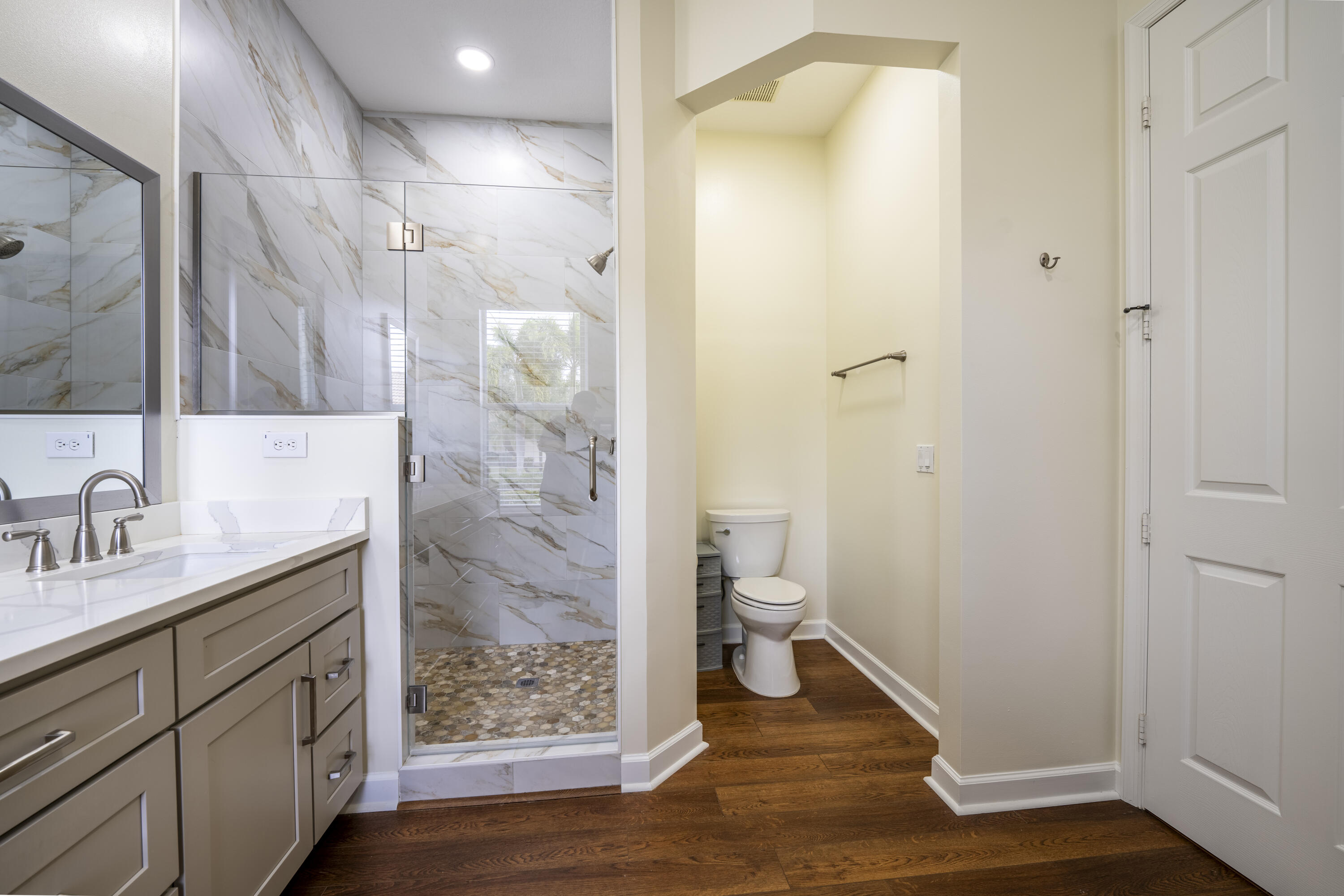 9184 Pumpkin Ridge Port St. Lucie, FL 34986 - Photo 30 of 74 a bathroom with a granite countertop sink toilet and shower