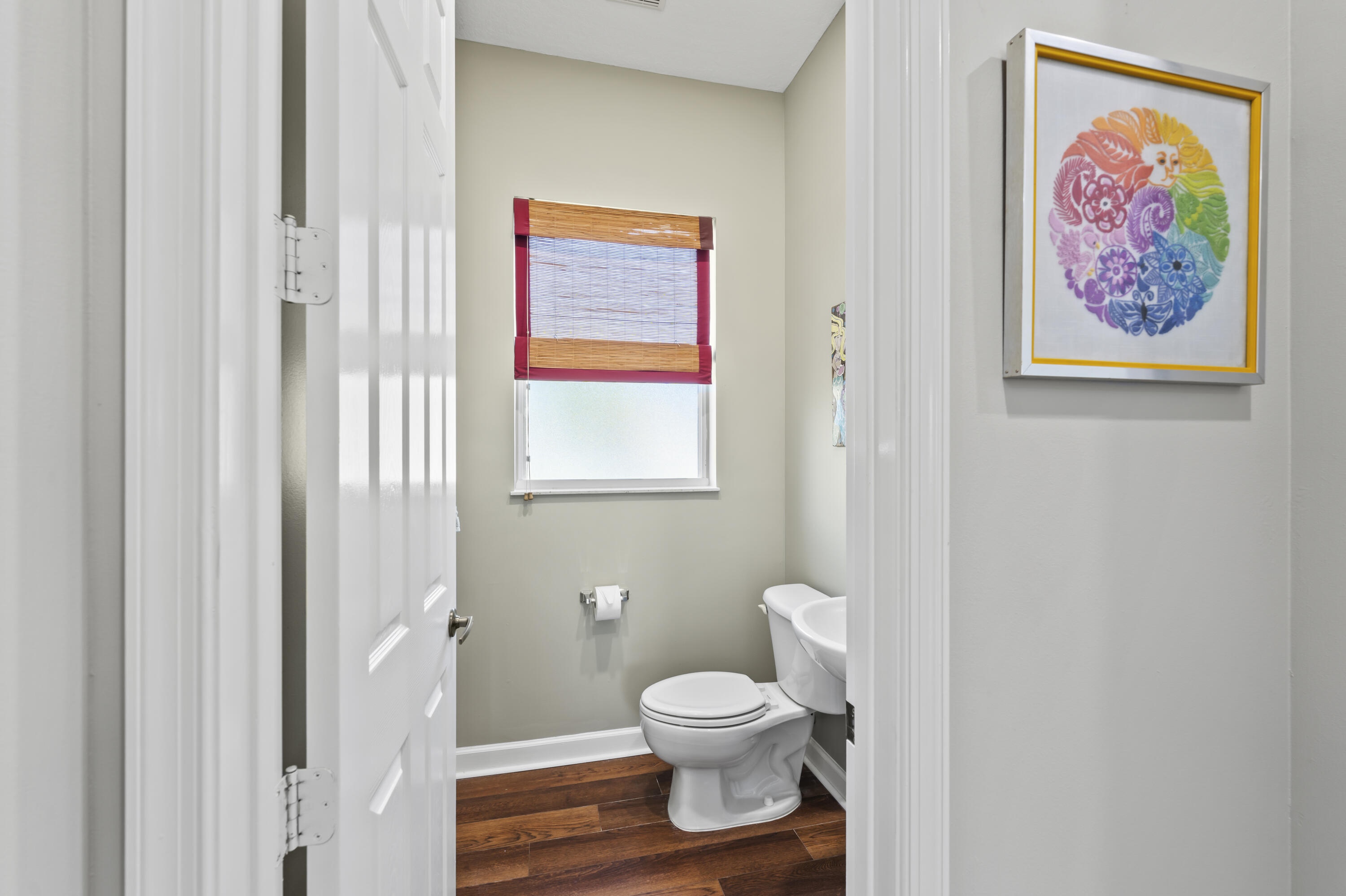 9184 Pumpkin Ridge Port St. Lucie, FL 34986 - Photo 37 of 74 a bathroom with a toilet and a painting on the wall
