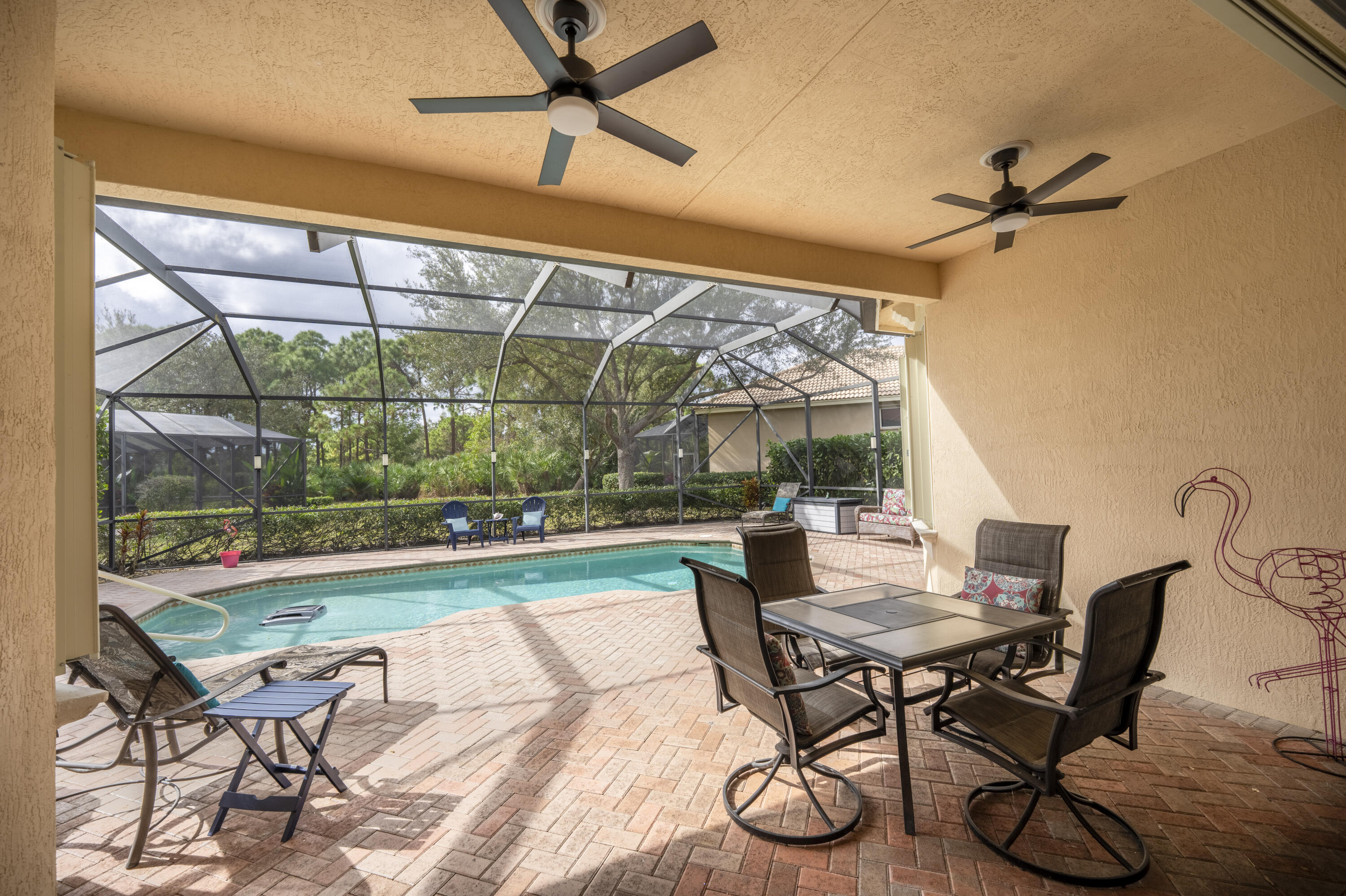 9184 Pumpkin Ridge Port St. Lucie, FL 34986 - Photo 41 of 74 a dining room with furniture and a floor to ceiling window