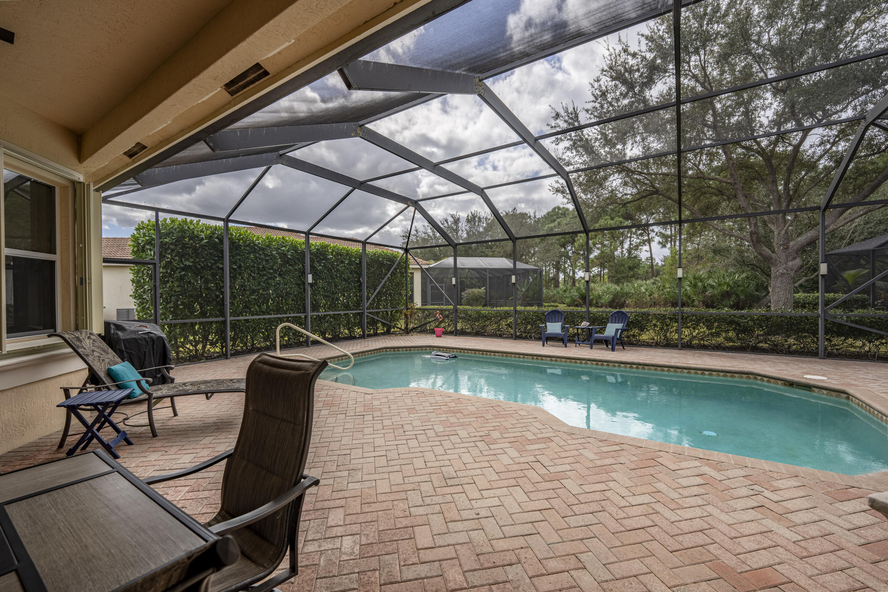 9184 Pumpkin Ridge Port St. Lucie, FL 34986 - Photo 44 of 74 a view of a swimming pool with a patio