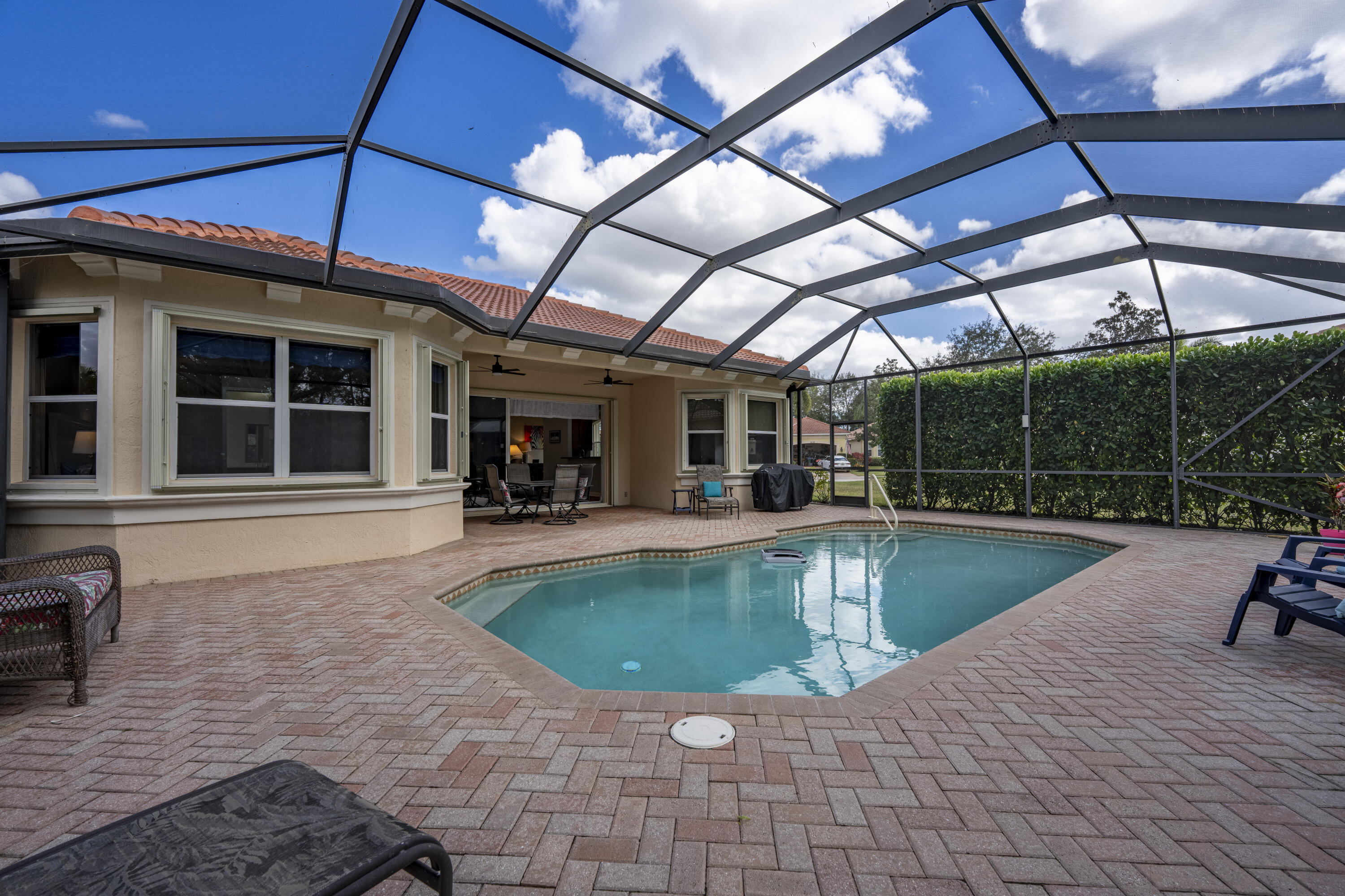 9184 Pumpkin Ridge Port St. Lucie, FL 34986 - Photo 45 of 74 a view of a swimming pool with a patio