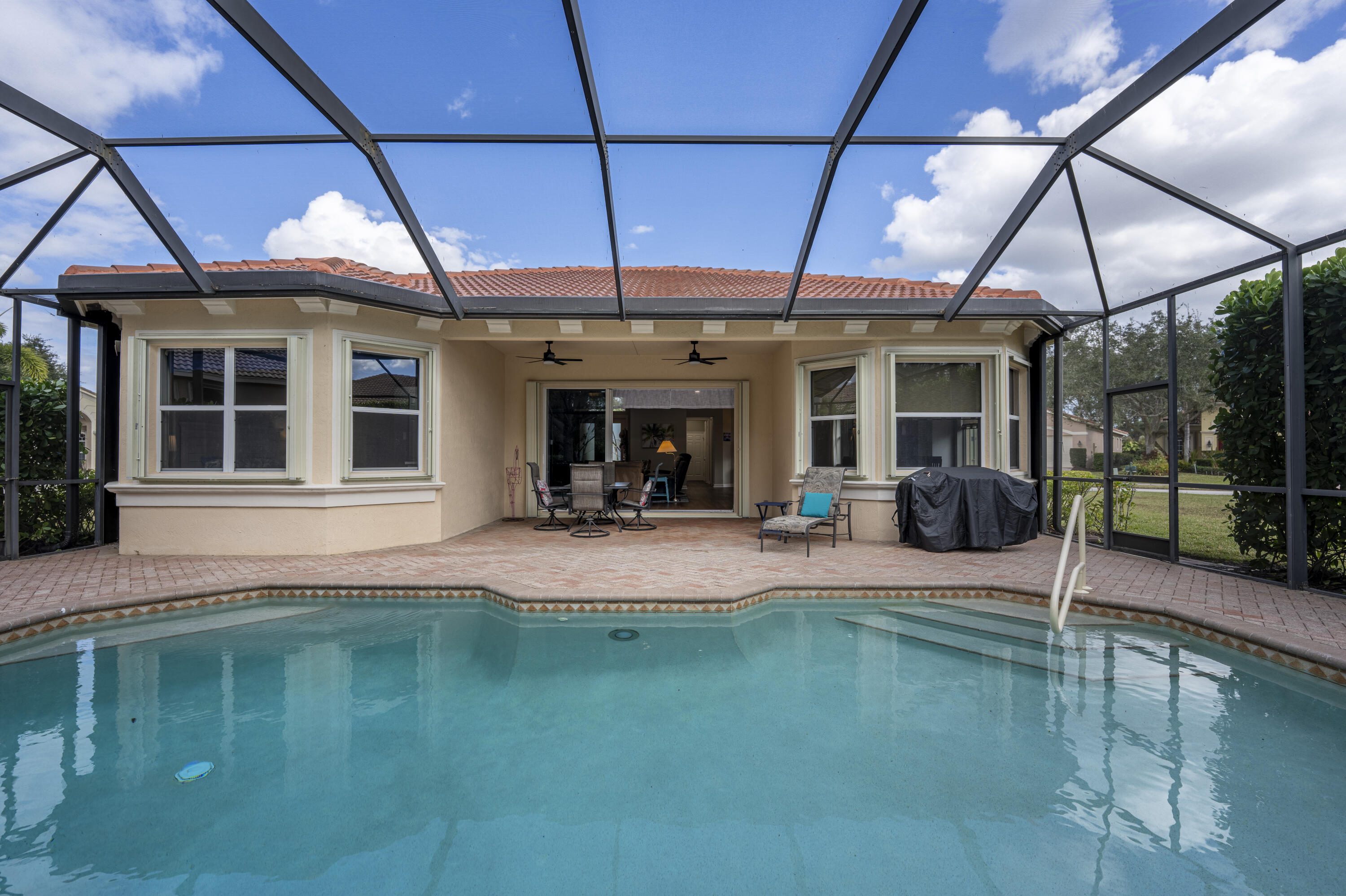 9184 Pumpkin Ridge Port St. Lucie, FL 34986 - Photo 46 of 74 a view of a swimming pool with a patio