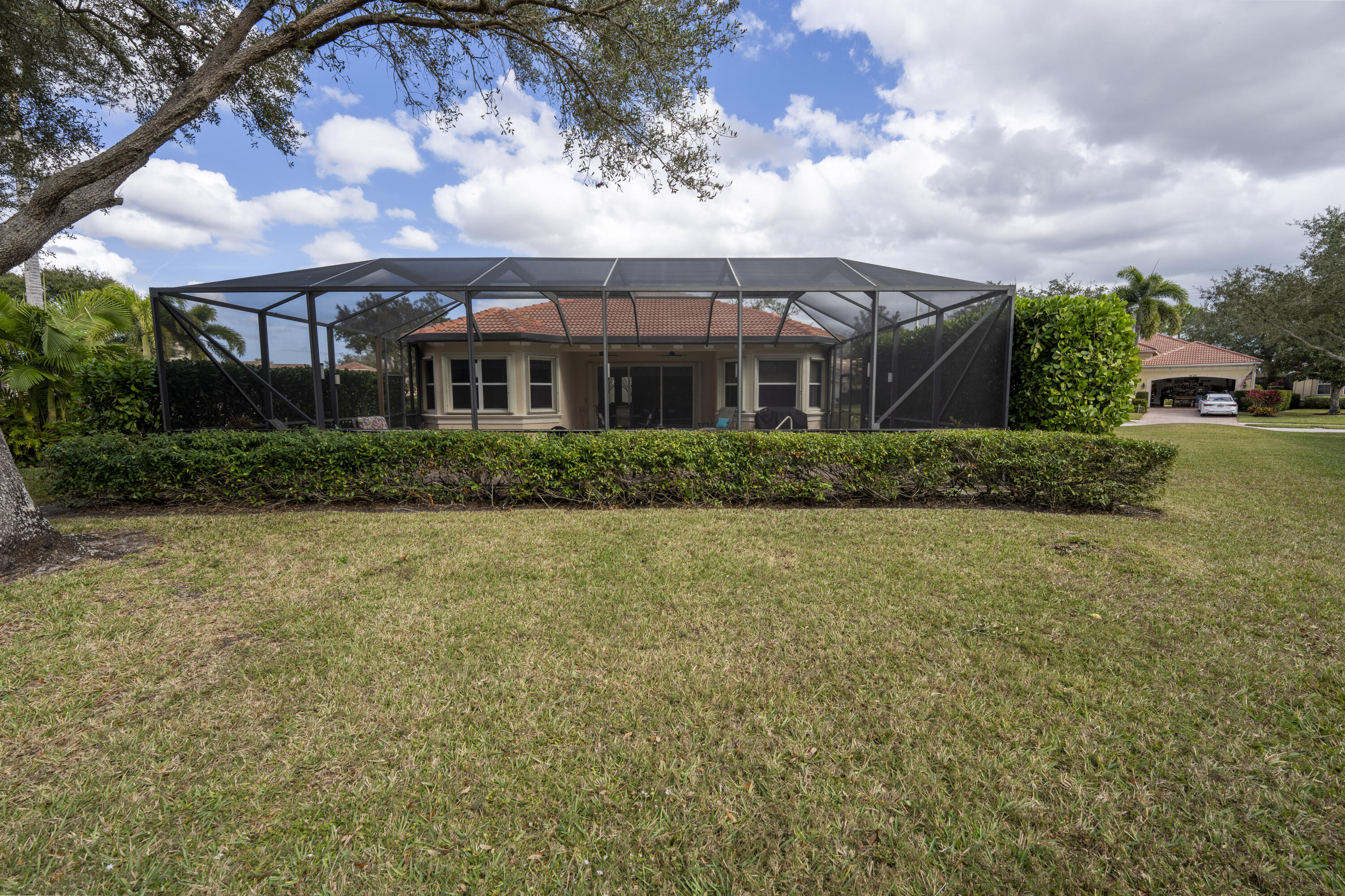 9184 Pumpkin Ridge Port St. Lucie, FL 34986 - Photo 51 of 74 a front view of house with yard and green space