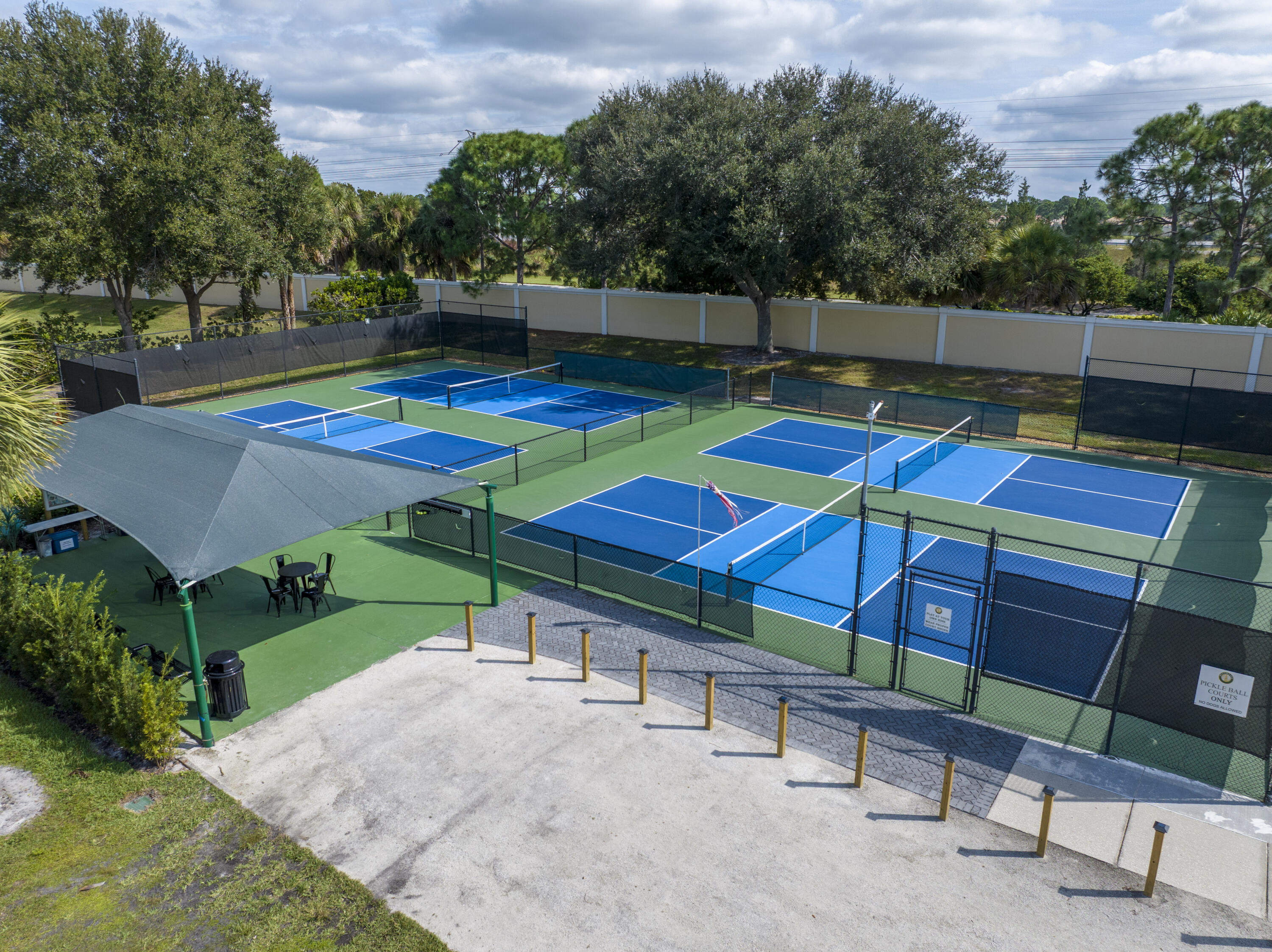 9184 Pumpkin Ridge Port St. Lucie, FL 34986 - Photo 57 of 74 an outdoor space with furniture and umbrella