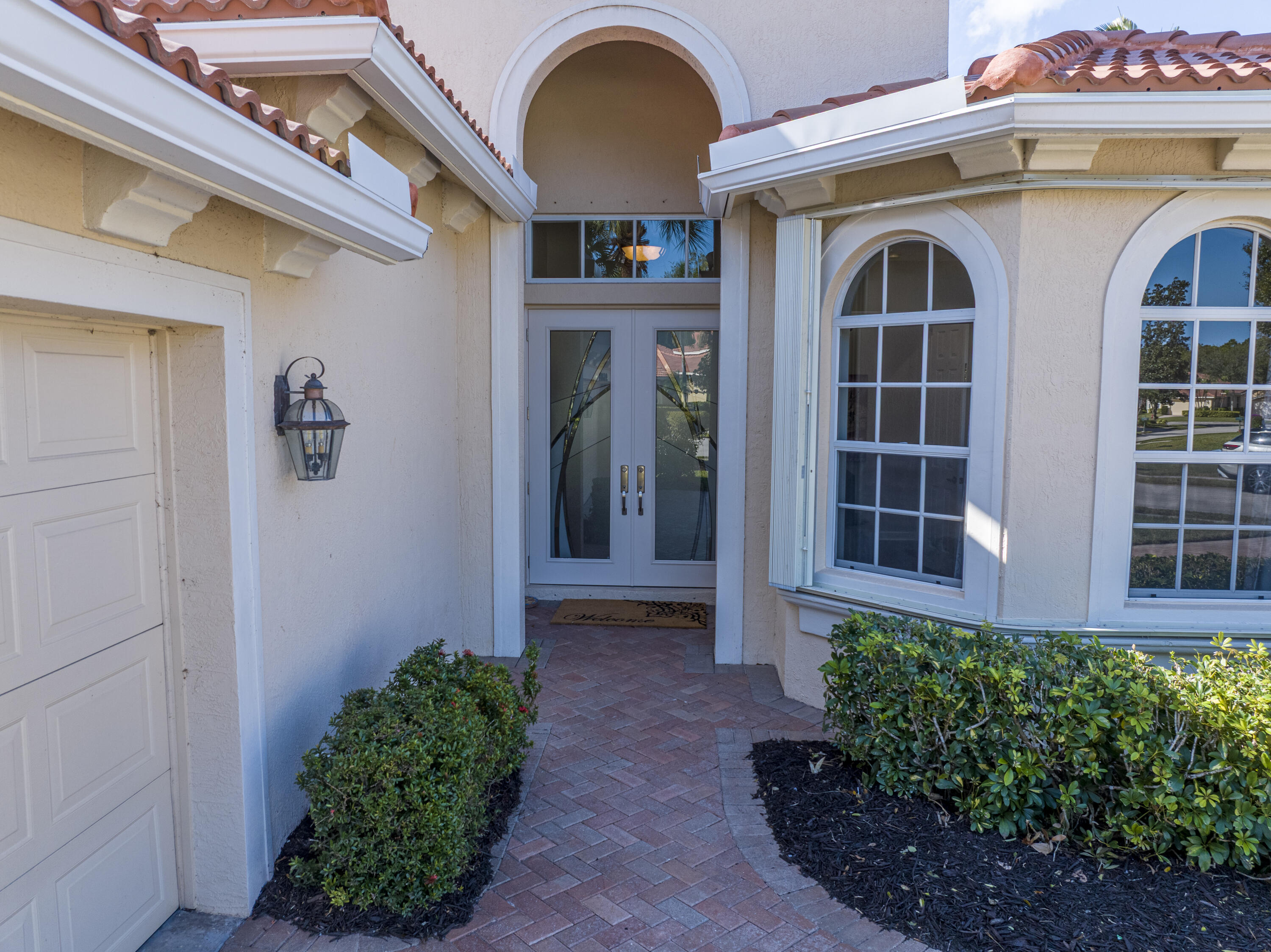 9184 Pumpkin Ridge Port St. Lucie, FL 34986 - Photo 8 of 74 a front view of a house with plants
