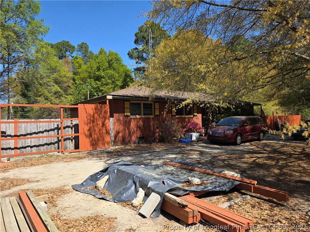 a view of a house with car parked on the road
