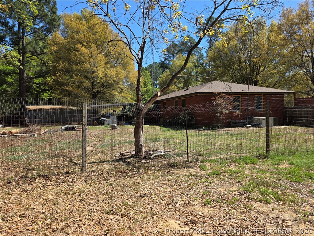5354 Muscat Road Hope Mills, NC 28348 - Photo 3 of 12 a backyard of a house with table and chairs