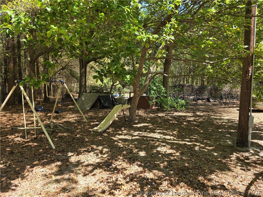 5354 Muscat Road Hope Mills, NC 28348 - Photo 7 of 12 a flag is sitting in the middle of a field