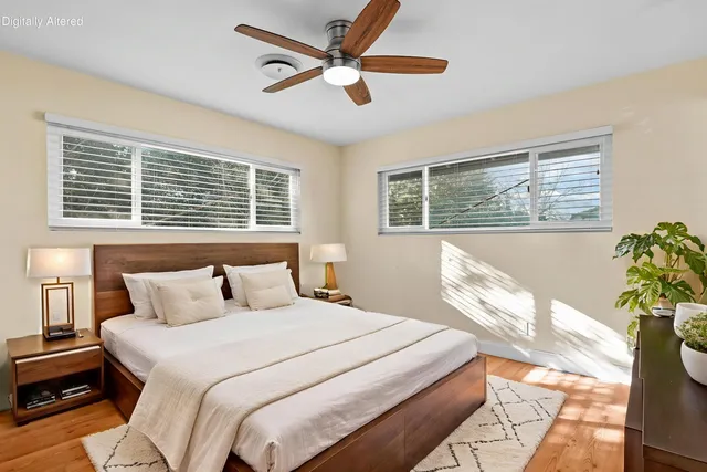 a bedroom with a large bed dresser and a window