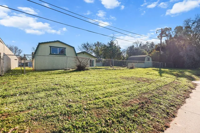 a swimming pool with outdoor seating and yard