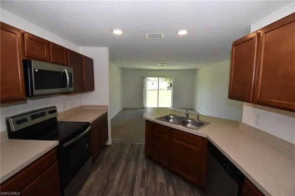 a kitchen with a sink a stove and microwave