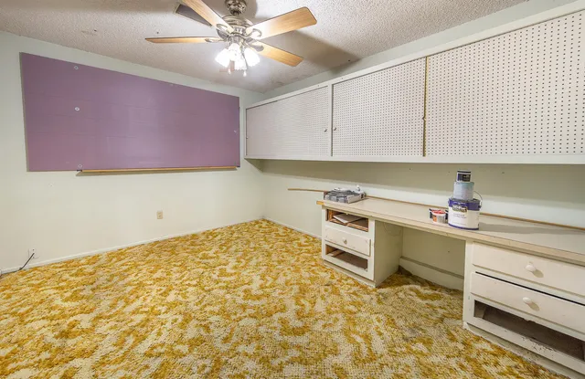 a kitchen with a stove a sink and cabinets