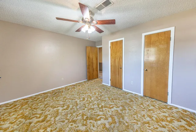 a view of a livingroom with a chandelier fan