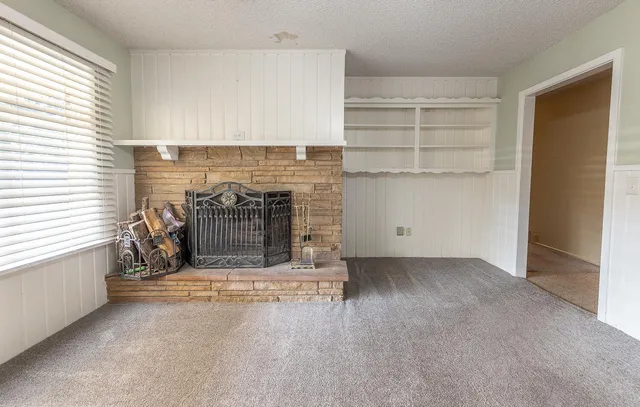 an empty room with a fireplace