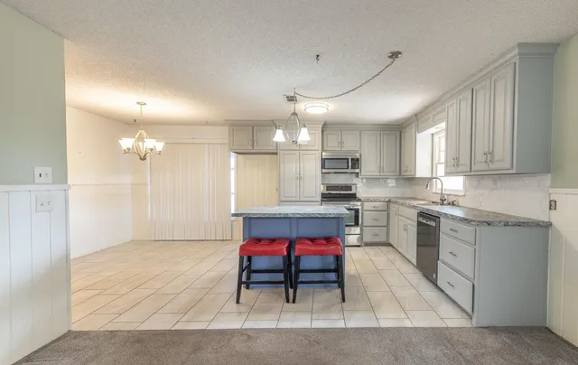a kitchen with refrigerator cabinets and microwave