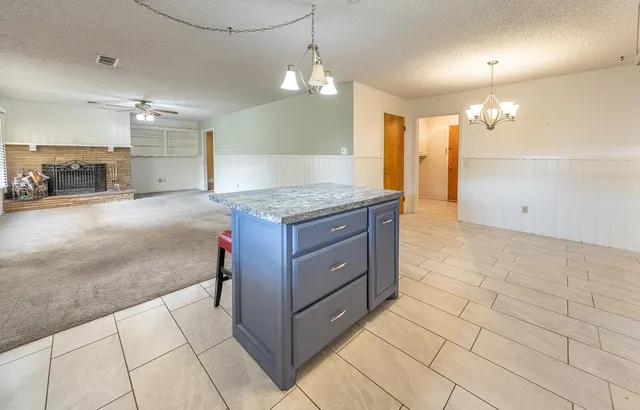 a bathroom with a granite countertop sink a mirror and a shower
